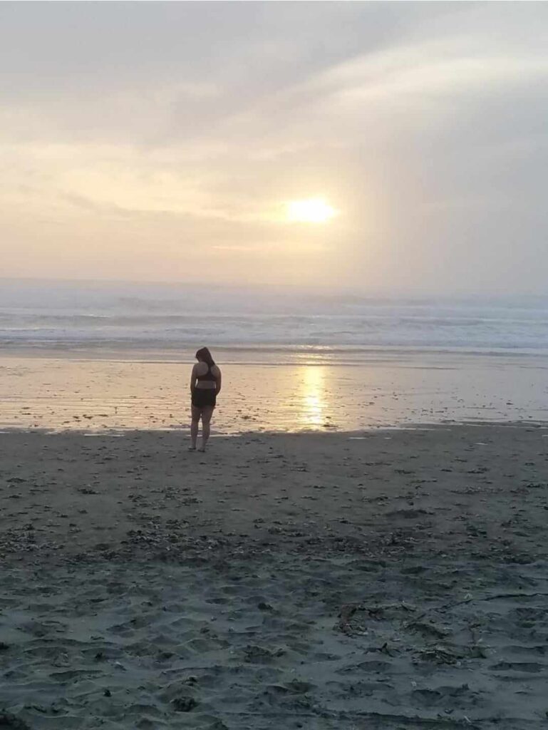 Oregon beach, girl looking at the ocean